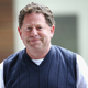 Activision Blizzard CEO Bobby Kotick smirks awkwardly at camera.